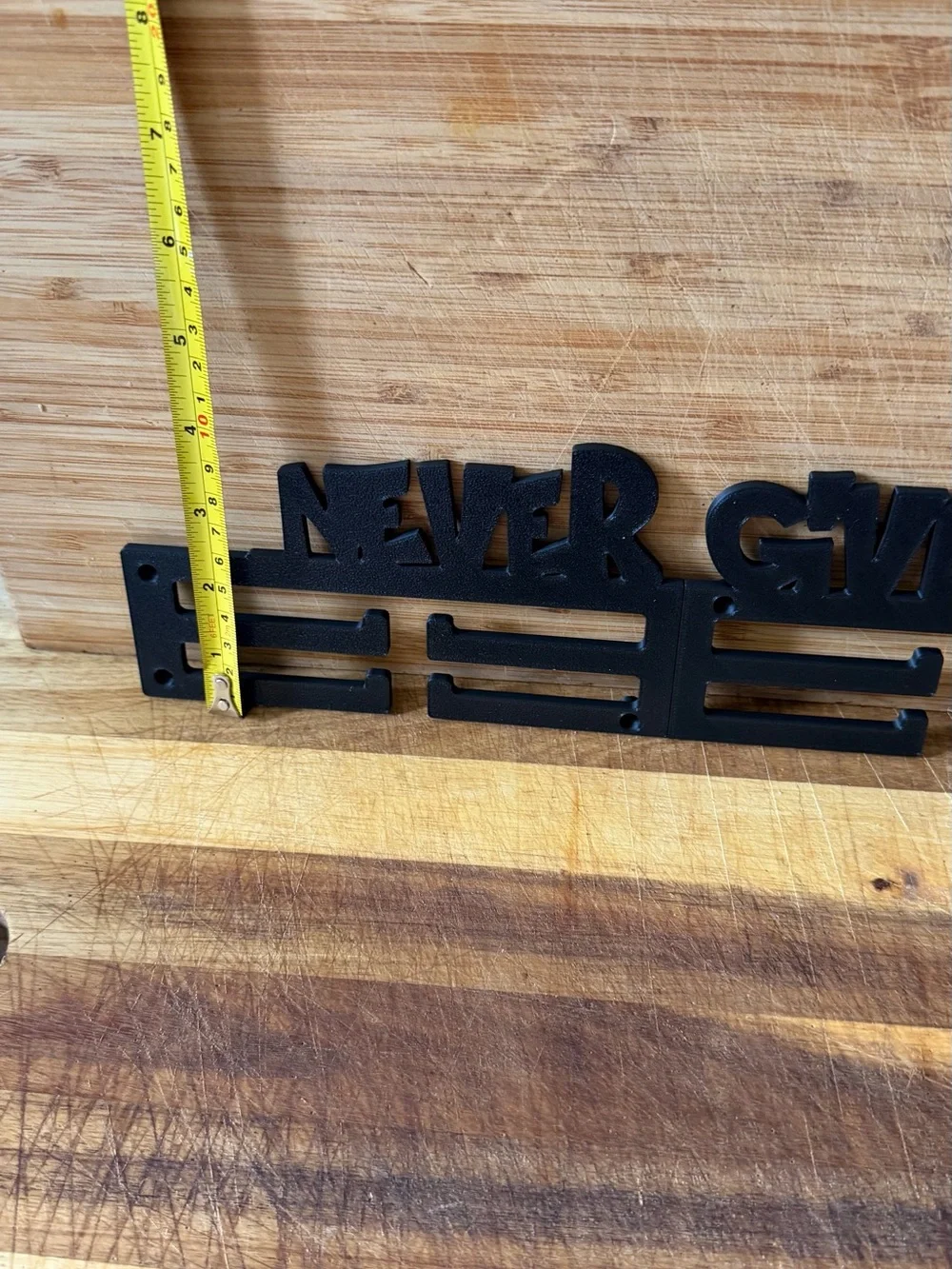 Never Give Up Black Metal Medal Hanger - Inspirational Wall Hook